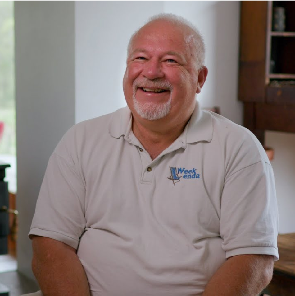 A photo of Weekenda's CEO, Pete Smith, sitting and smiling.