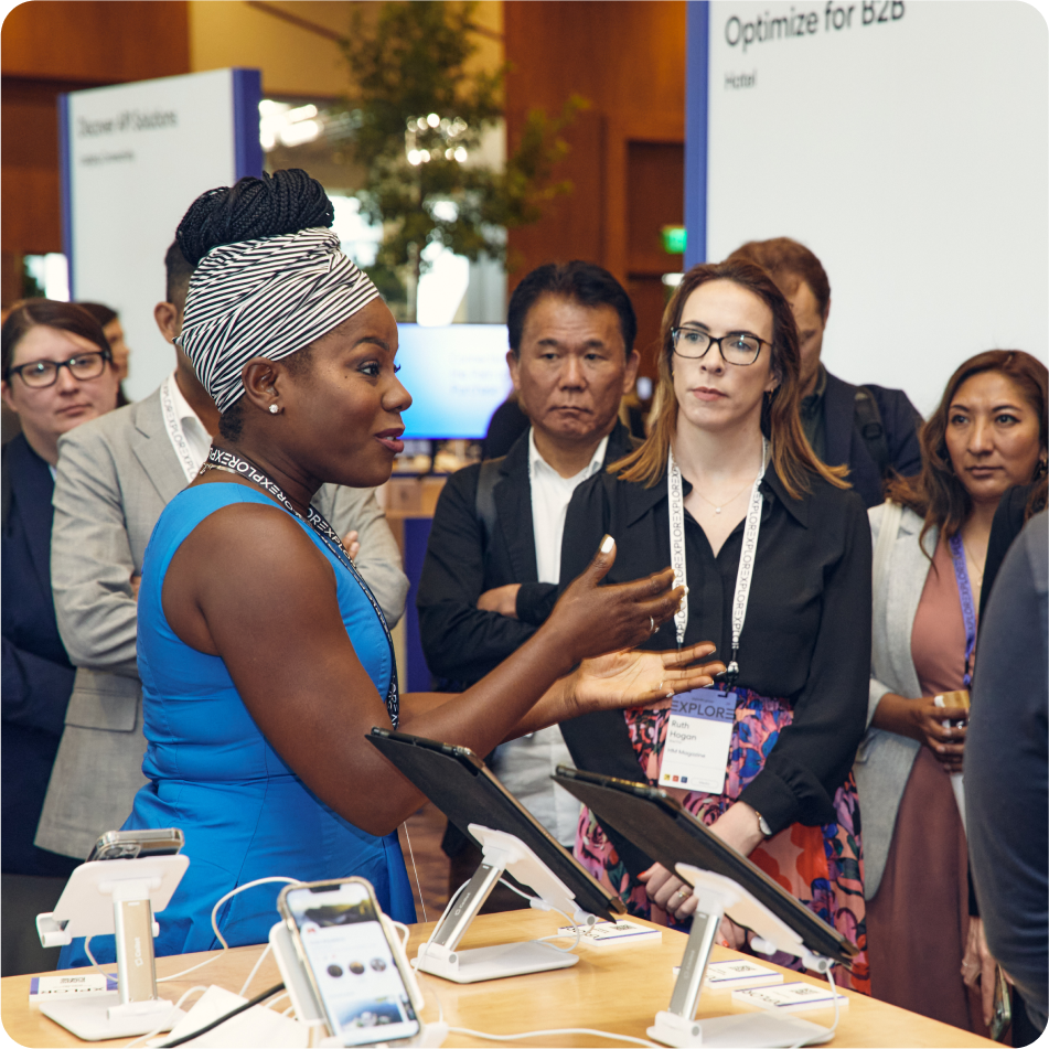 Attendees and travel influencer, Oneika Raymond, at the Travel Shop booth at EXPLORE 24 Tech Experience Lounge