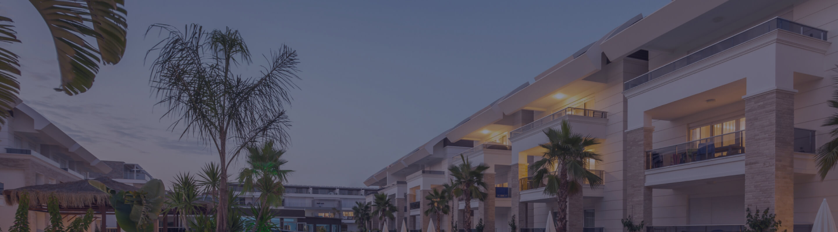 A multi-level hotel facade at dusk