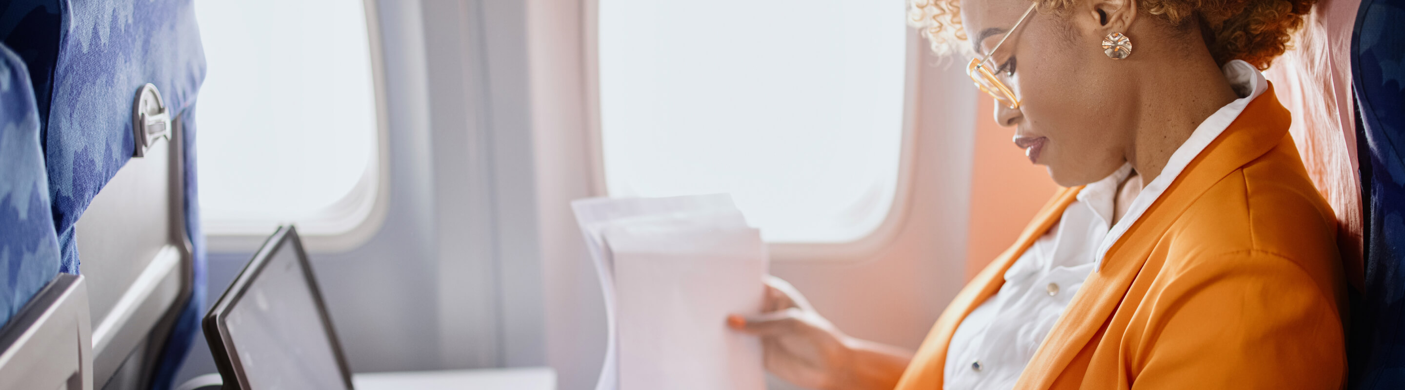 A woman works on her laptop during her flight.