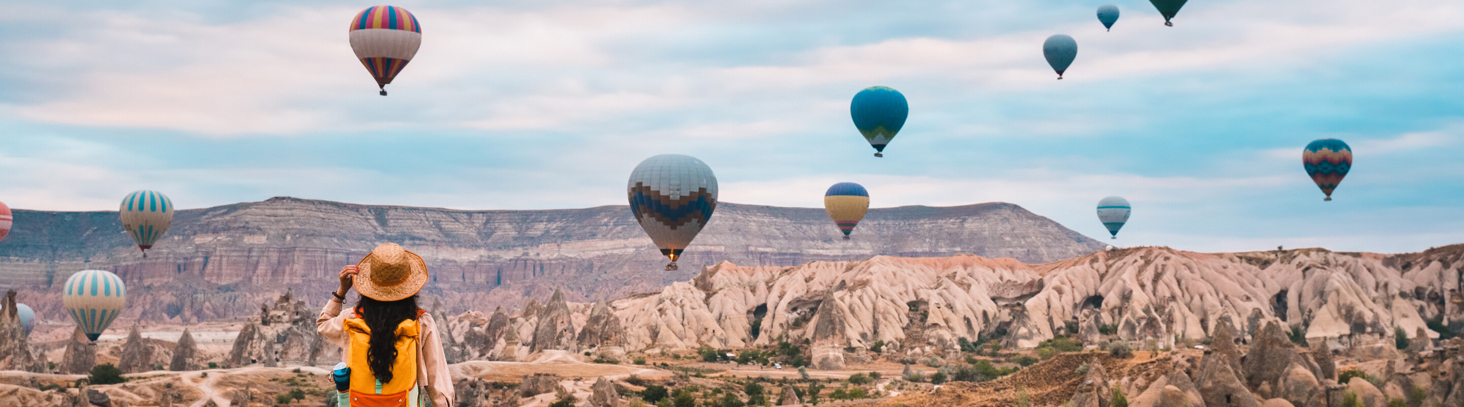 A woman watches a hot air balloon festival in Cappadocia, Turkey.