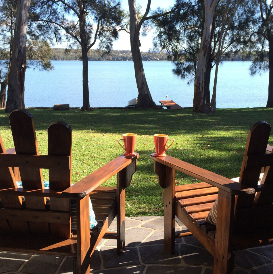 Two wooden benches beside a lake