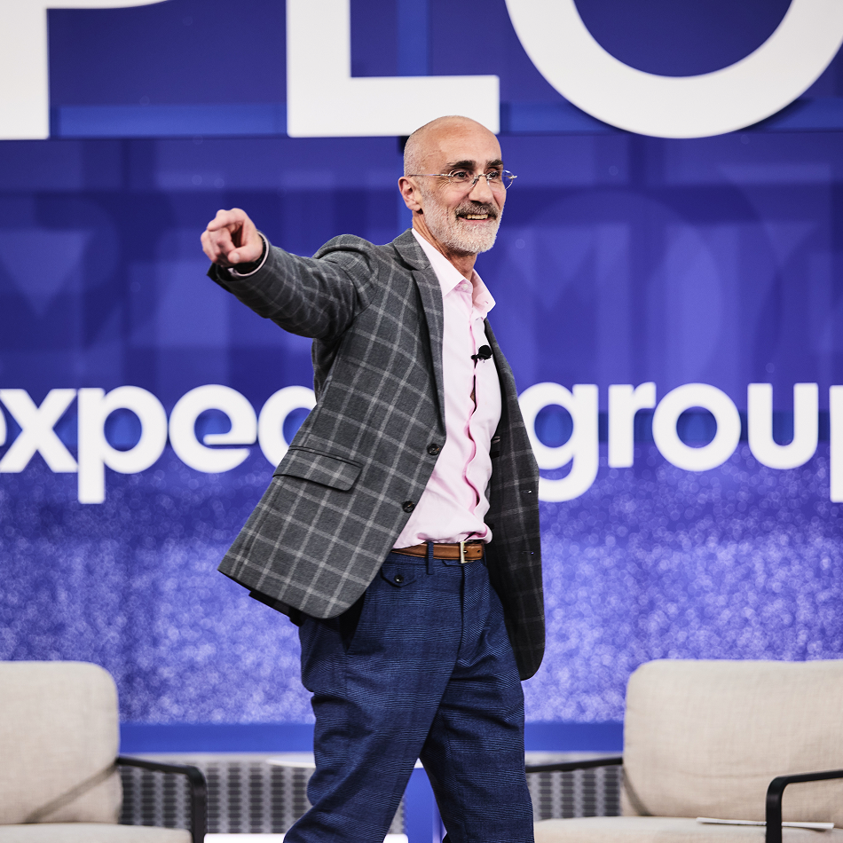 Arthur Brooks speaking on stage at a EXPLORE event.