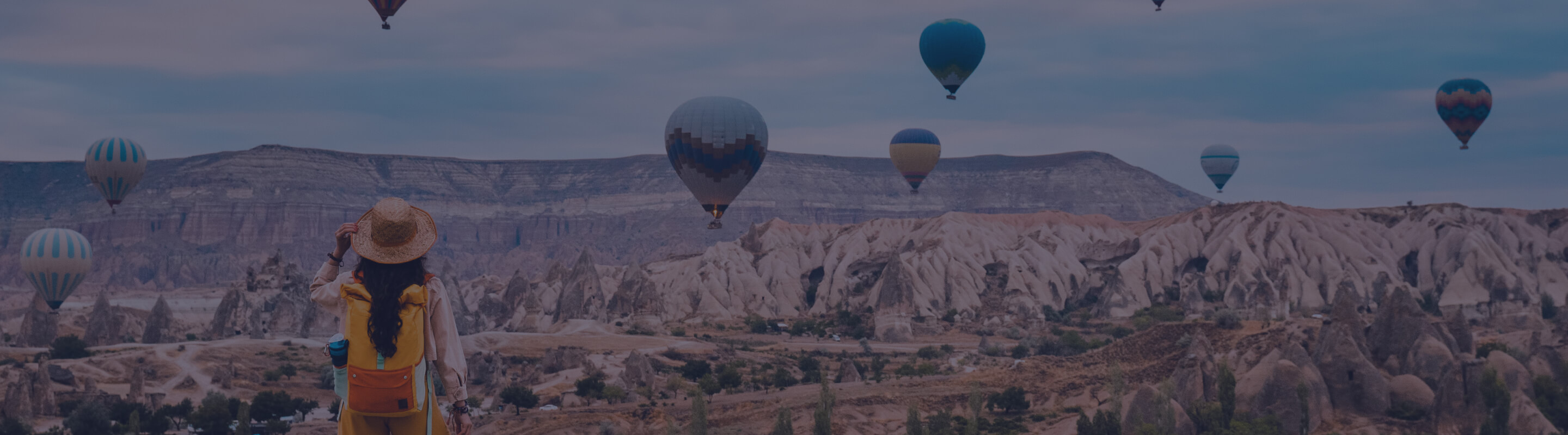 A woman watches a hot air balloon festival in Cappadocia, Turkey.