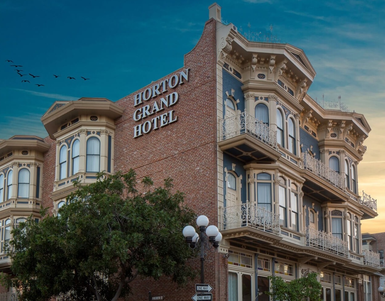 Exterior of a Victorian architectural style hotel with blue sky.