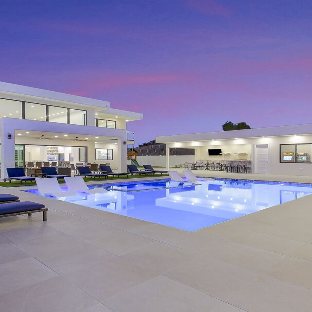 Photograph of a house's backyard with a modern pool