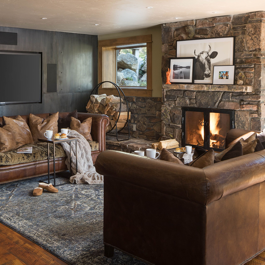 Photograph of a warm living room with a fireplace