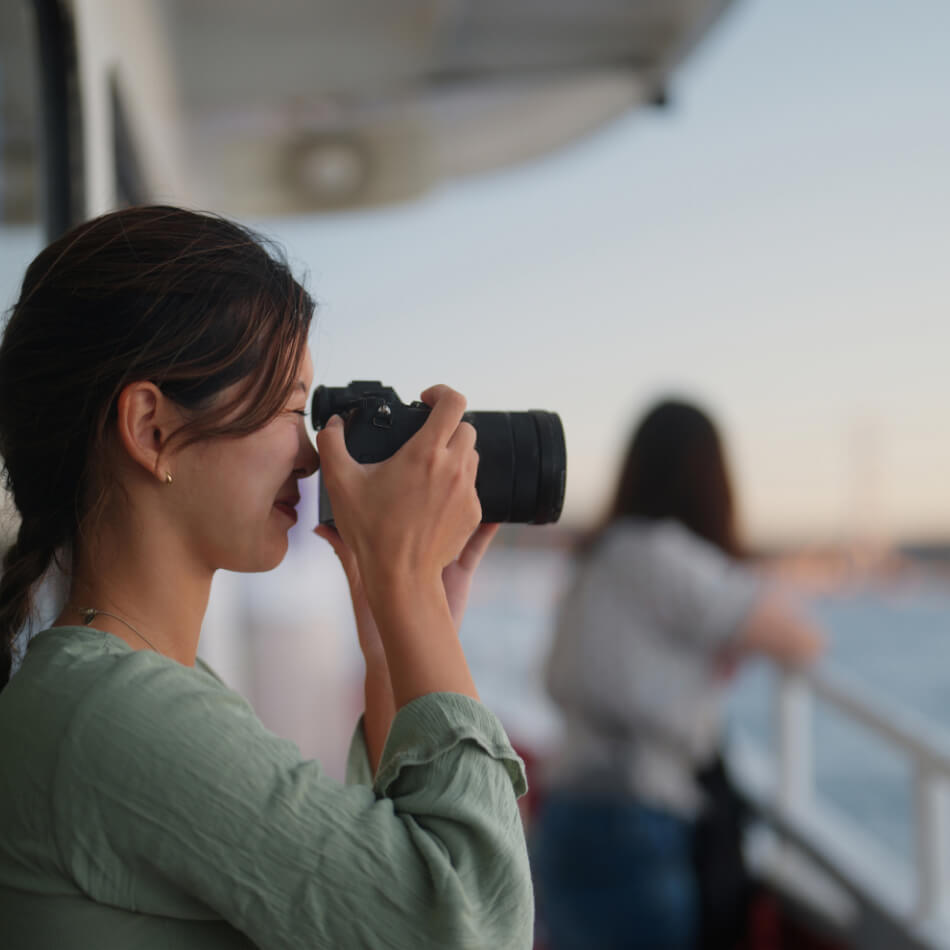 A person on a boat taking a photo of their surroundings using a digital camera