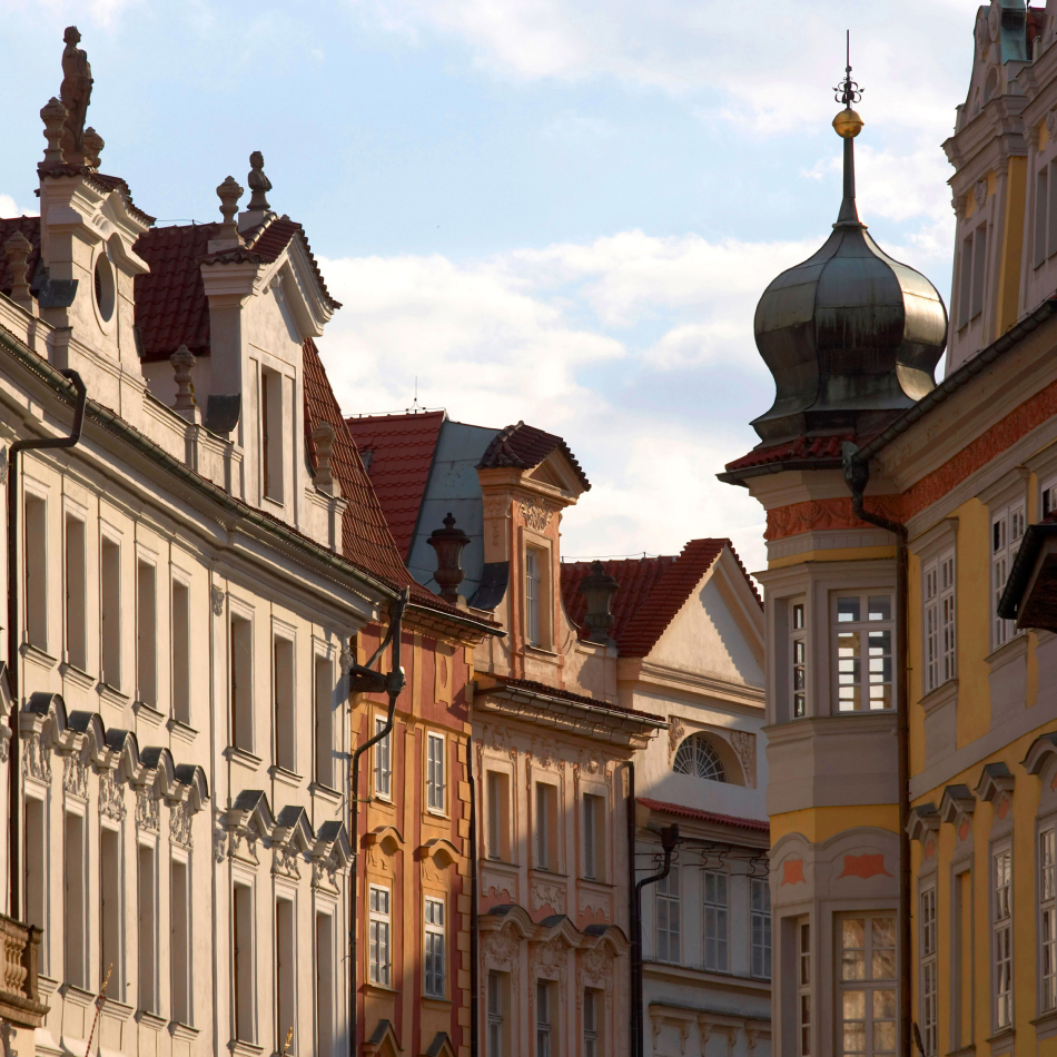 Decorative multi-story hotel with towers and intricate architectural details in warm sunlight.