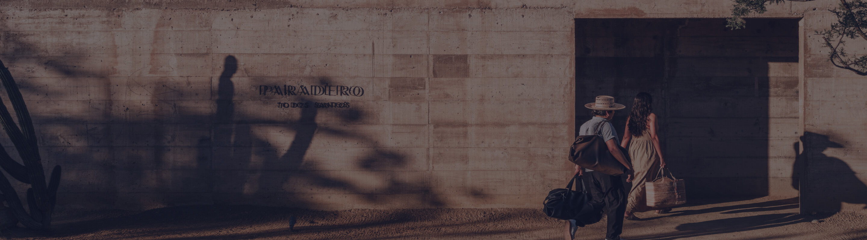 Two people walking into the Paradero Hotel