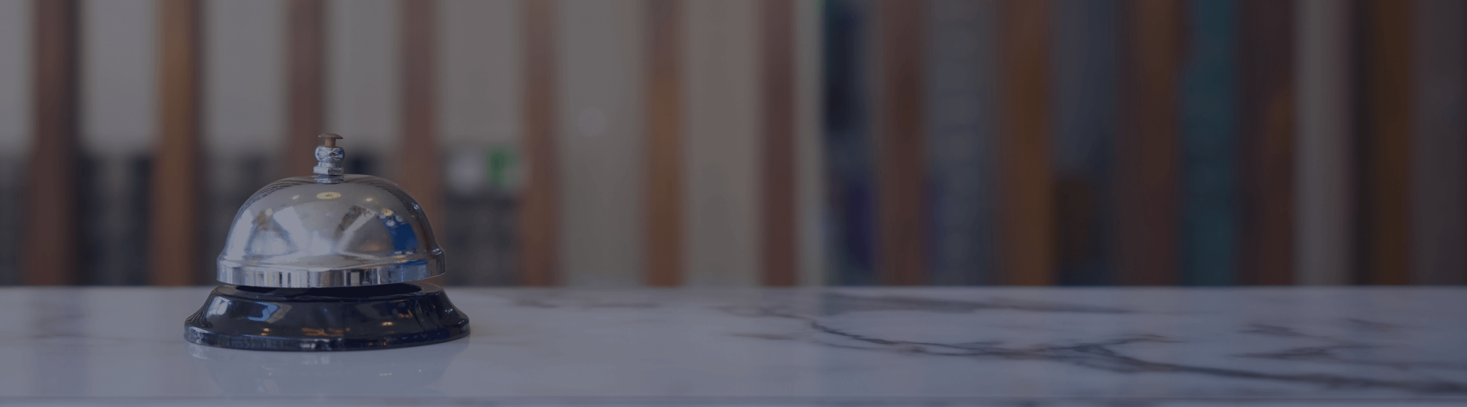 A close-up shot of a bell on a reception desk