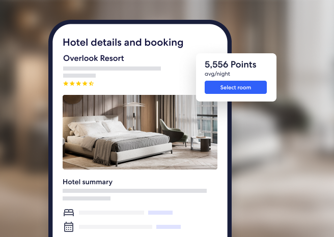 Two women with suitcases speaking with a front desk worker at a hotel check in.