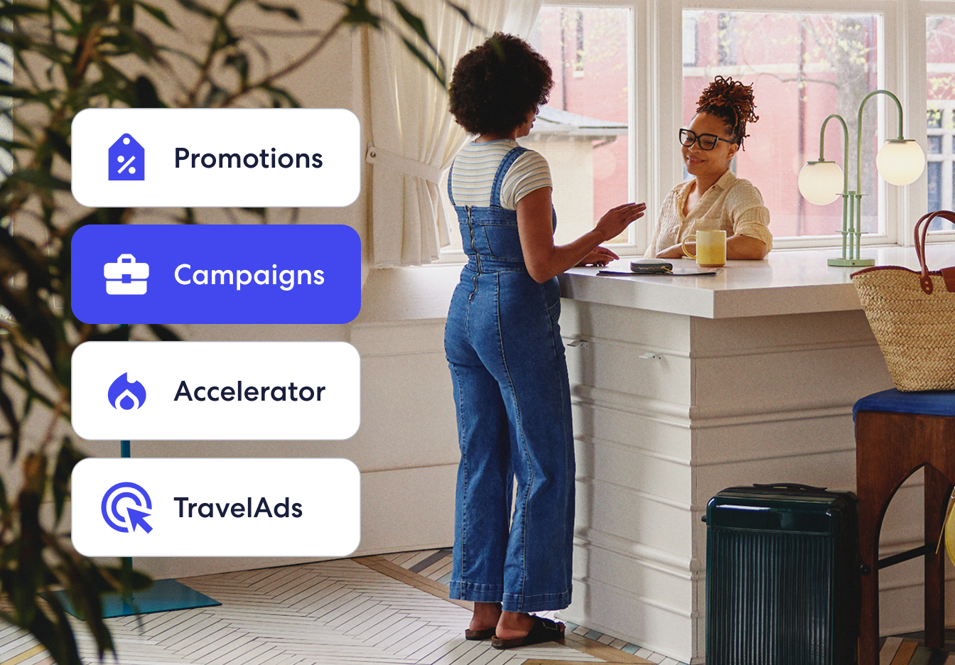 Two people interacting at the counter, with an overlaid mobile UI displaying partner hotel tools for Promotions, Campaigns, Accelerator, and TravelAds, combining real-life context with digital product interface elements